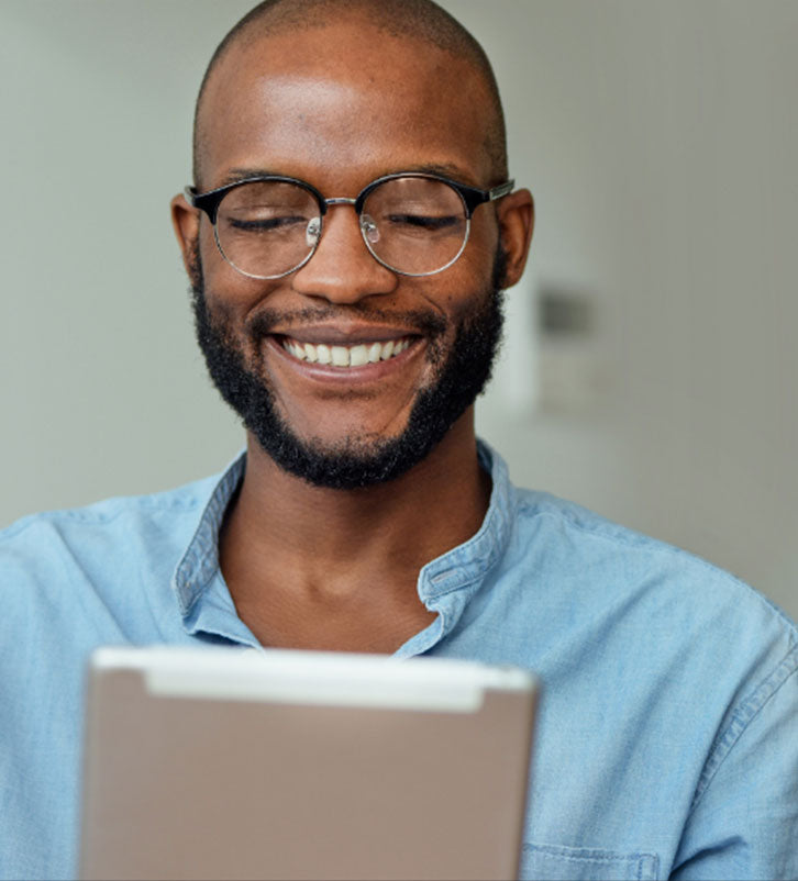 young black man wearing glasses reading